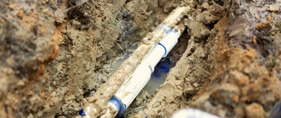 Exposed irrigation system pipes underground in Memphis, TN.