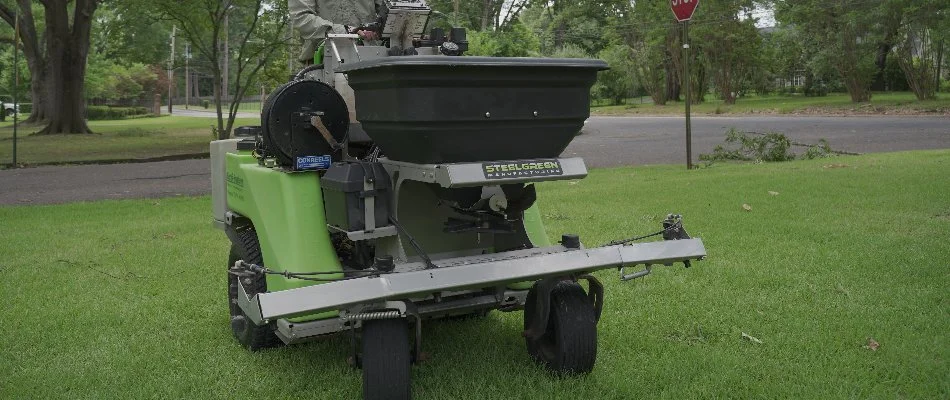 Granular fertilizer machine spreader on a lawn in Memphis, TN.