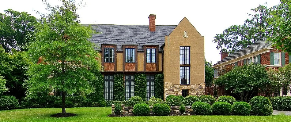 House in Memphis, TN, with dense, green trees and shrubs.