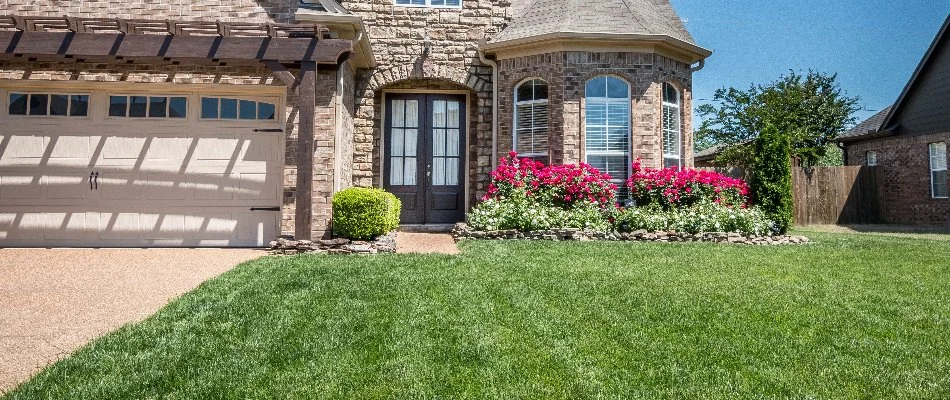 House in Memphis, TN, with a healthy, green lawn.