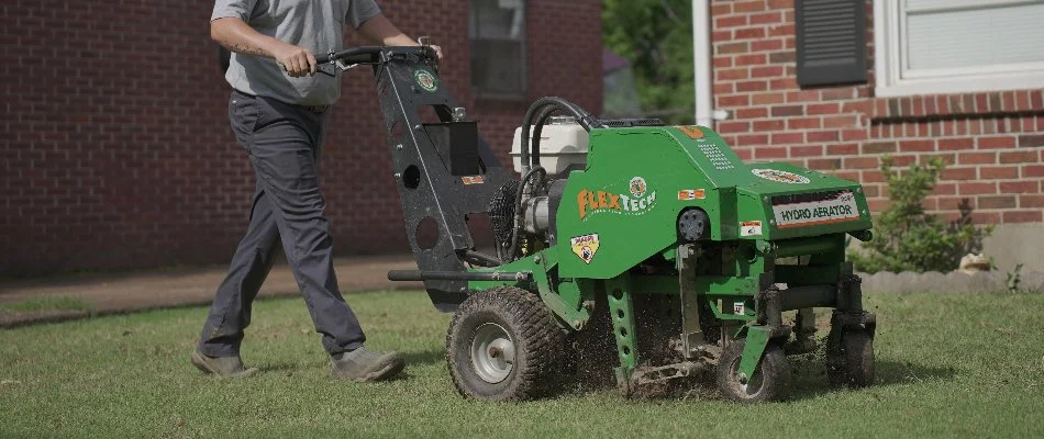 Man aerating a lawn in Memphis, TN.