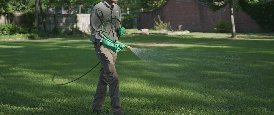 Tech spraying pre-emergent weed control on a lawn in Memphis, TN.