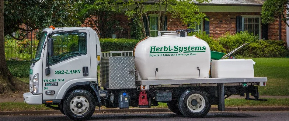 White lawn care truck on the street in Memphis, TN.