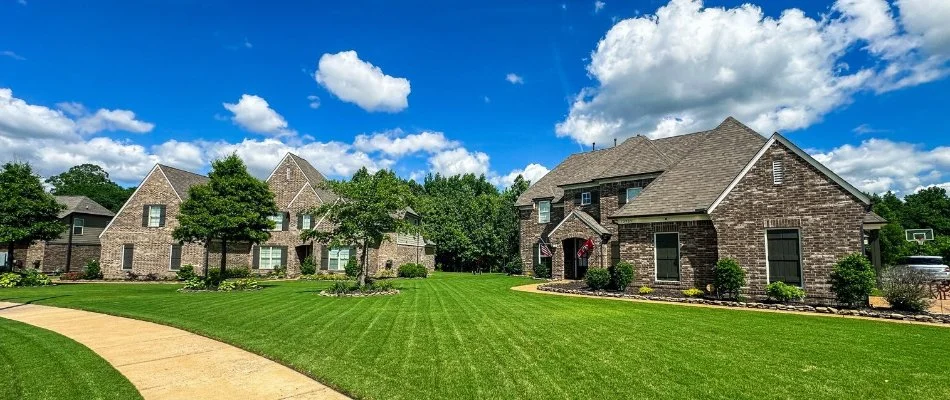 A house with bright green lawn in Rosemark, TN.
