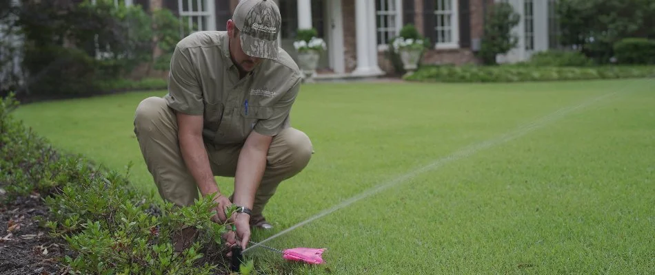 Person repairing an irrigation system on a property in Memphis, TN.