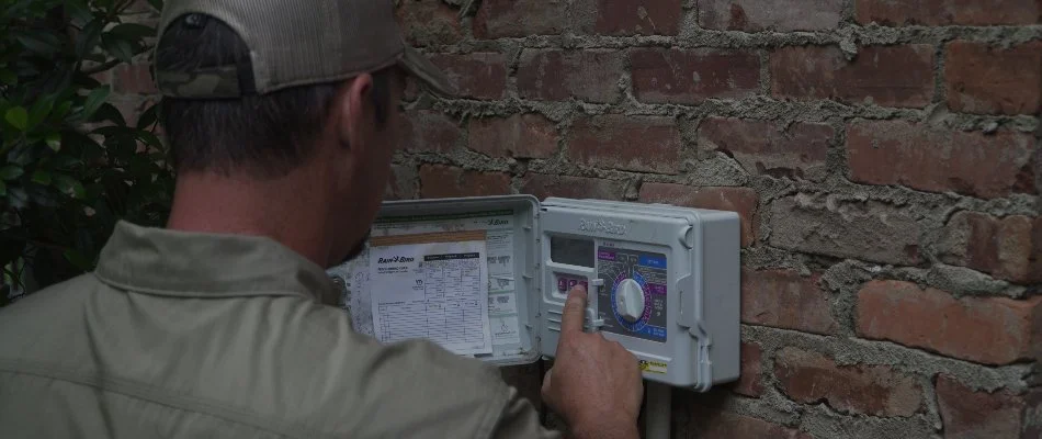 Worker performing an irrigation startup service in Memphis, TN.