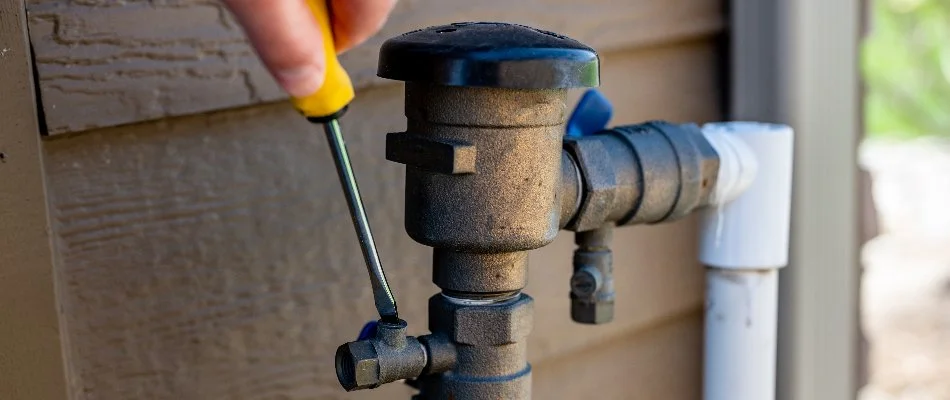 Worker performing an irrigation startup service in Memphis, TN.