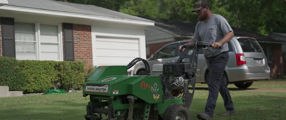 Worker aerating a lawn in Memphis, TN.