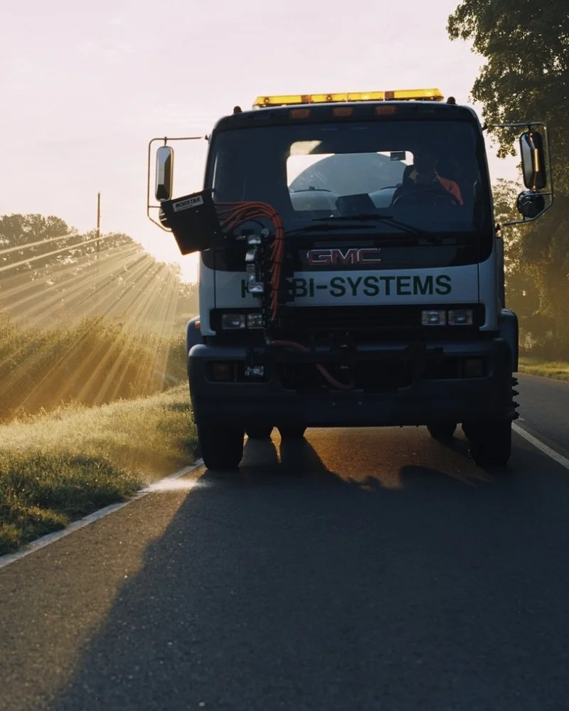 Herbi-Systems truck on road.